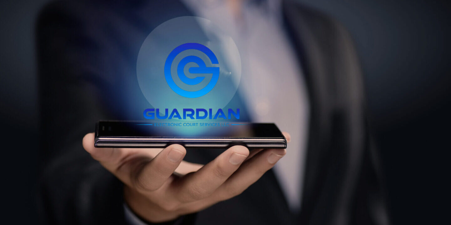 A man holding up his phone with the word " guardians " on it.